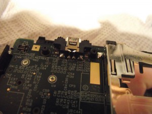 Big blobs of solder secure the charge port in place, unlike the weak connection in earlier models