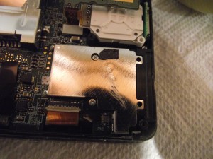 Silver, rather than black, screws beneath the SD card slot.
